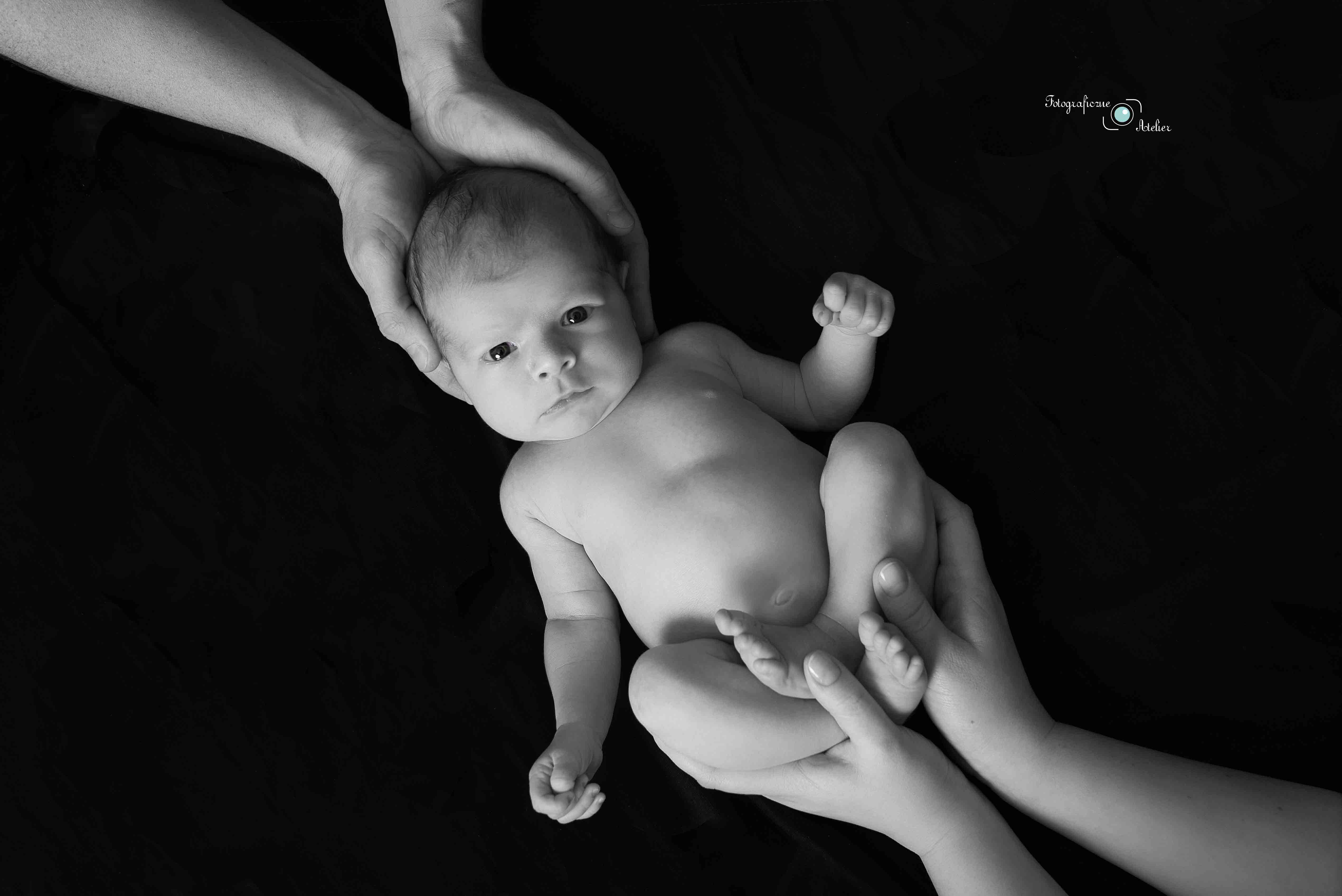 noworodek w objęciach rodziców Poznań fotografia